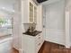 Kitchen featuring white cabinets, black countertops and wooden floors at 1605 Allen St, Charlotte, NC 28205