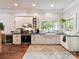 Bright kitchen features white cabinets, stainless steel appliances, and hardwood floors at 1605 Allen St, Charlotte, NC 28205