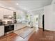 Well-lit kitchen features white cabinets, farmhouse sink, and hardwood floors at 1605 Allen St, Charlotte, NC 28205