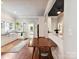 Kitchen featuring white cabinets, black countertops, stainless appliances and a dining area at 1605 Allen St, Charlotte, NC 28205
