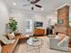 Living room with exposed brick fireplace, leather sofa, and ceiling fan at 1605 Allen St, Charlotte, NC 28205