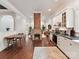 Open concept living space features hardwood floors, white cabinets and brick fireplace at 1605 Allen St, Charlotte, NC 28205