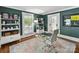 Well-lit office featuring built-in shelving, a modern desk, and classic design elements at 1605 Allen St, Charlotte, NC 28205