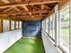Interior view of shed showing wood beams, blue wall and lots of light from surrounding windows at 1605 Allen St, Charlotte, NC 28205