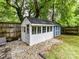 Exterior view of backyard shed featuring white and blue painted exterior at 1605 Allen St, Charlotte, NC 28205