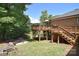 Multi-tiered backyard with a deck, patio, and lush greenery at 16433 Grapperhall Dr, Huntersville, NC 28078