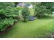 Sprawling backyard featuring a trampoline and lush green lawn at 16433 Grapperhall Dr, Huntersville, NC 28078