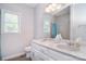 Bathroom featuring dual sinks, granite countertops, stylish fixtures, and a tiled shower at 16433 Grapperhall Dr, Huntersville, NC 28078