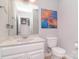 Bathroom featuring a stylish vanity, elegant fixtures, and a decorative piece of artwork at 16433 Grapperhall Dr, Huntersville, NC 28078