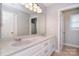 Bathroom with double sink vanity, modern lighting, white cabinetry, and granite countertops at 16433 Grapperhall Dr, Huntersville, NC 28078
