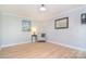 Comfortable bedroom featuring hard wood floors, neutral paint, and modern decor at 16433 Grapperhall Dr, Huntersville, NC 28078