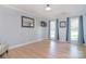 Cozy bedroom with wood floors, light gray walls, and ample natural light from two large windows at 16433 Grapperhall Dr, Huntersville, NC 28078