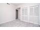 Neutral bedroom featuring a closet and doorway with carpeted floor at 16433 Grapperhall Dr, Huntersville, NC 28078