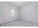 Bright bedroom featuring a window with natural light and soft gray carpet at 16433 Grapperhall Dr, Huntersville, NC 28078