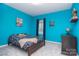 Bedroom featuring bright blue walls, a comfortable bed, and modern accents at 16433 Grapperhall Dr, Huntersville, NC 28078
