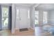 Bright entryway featuring beautiful wood floors, fresh paint, and sidelight windows at 16433 Grapperhall Dr, Huntersville, NC 28078