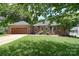 Charming brick home with a well-manicured lawn and a two-car garage, perfect for curb appeal at 16433 Grapperhall Dr, Huntersville, NC 28078