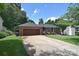Brick home featuring an attached two-car garage, neat landscaping, and a welcoming driveway at 16433 Grapperhall Dr, Huntersville, NC 28078
