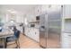 Well-lit kitchen featuring white cabinets, granite countertops, stainless steel appliances, and modern fixtures at 16433 Grapperhall Dr, Huntersville, NC 28078
