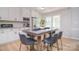 Bright kitchen featuring white cabinets, stainless steel appliances, and a stylish central dining table at 16433 Grapperhall Dr, Huntersville, NC 28078