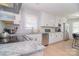 Bright kitchen with white cabinets, stainless steel appliances, granite countertops, and an island with bar seating at 16433 Grapperhall Dr, Huntersville, NC 28078