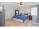 Cozy main bedroom with ceiling fan, hardwood floors, neutral walls, and natural light at 16433 Grapperhall Dr, Huntersville, NC 28078