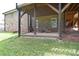 Covered patio offering a cozy outdoor seating area and backyard views at 16433 Grapperhall Dr, Huntersville, NC 28078