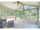 Cozy sunroom with large windows offering views of the landscaped backyard at 16433 Grapperhall Dr, Huntersville, NC 28078