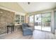 Relaxing sunroom with brick wall, large windows, and access to the outdoor deck at 16433 Grapperhall Dr, Huntersville, NC 28078