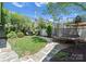 Lush backyard featuring a trampoline, manicured lawn, and mature landscaping at 236 Wales Ave, Charlotte, NC 28209