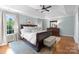 Bright bedroom with hardwood floors, tray ceiling, and ample natural light from large windows at 236 Wales Ave, Charlotte, NC 28209