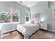 Bright bedroom with multiple windows and a cozy bed adorned with decorative pillows and soft textiles at 236 Wales Ave, Charlotte, NC 28209