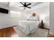 Bright bedroom with a ceiling fan, and hardwood floors with white walls and neutral accents at 236 Wales Ave, Charlotte, NC 28209