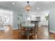 Cozy dining area featuring a glass table, chandelier, and views into the kitchen at 236 Wales Ave, Charlotte, NC 28209