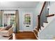 Welcoming entryway featuring hardwood floors, staircase, and front door with window panes at 236 Wales Ave, Charlotte, NC 28209