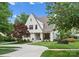 Charming white brick home with a manicured lawn and a curved driveway at 236 Wales Ave, Charlotte, NC 28209