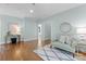 Stylish living room with hardwood floors, soft blue walls, and a comfortable sitting area at 236 Wales Ave, Charlotte, NC 28209