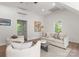 Bright and airy living room featuring neutral decor, large windows, and comfortable seating at 236 Wales Ave, Charlotte, NC 28209