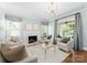 Bright and airy living room featuring a fireplace, neutral decor, and large windows at 236 Wales Ave, Charlotte, NC 28209