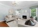 Comfortable living room with a fireplace, plush seating, and natural light at 236 Wales Ave, Charlotte, NC 28209