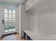 Well-organized mudroom with built-in storage, hooks, a bench, and an exterior door at 236 Wales Ave, Charlotte, NC 28209