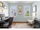 Well-lit home office featuring a desk, chair, and framed degrees displayed on the walls at 236 Wales Ave, Charlotte, NC 28209