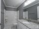 Bathroom featuring granite countertop, white cabinets, framed mirror and a shower-tub combo at 251 Hall Spencer Rd, Catawba, SC 29704