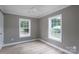 Bedroom with hardwood floor, gray walls and trim, two windows providing natural light, and ceiling fan at 251 Hall Spencer Rd, Catawba, SC 29704