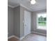 Neutral-toned bedroom featuring a ceiling fan, white door, and a window providing a view of the outdoors at 251 Hall Spencer Rd, Catawba, SC 29704