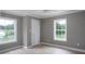Bedroom with hardwood floor, gray walls, white trim, with two windows providing natural light and ventilation at 251 Hall Spencer Rd, Catawba, SC 29704