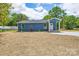Inviting single-story home featuring a well-manicured lawn and a cozy, covered entryway at 251 Hall Spencer Rd, Catawba, SC 29704