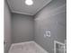 Bright laundry room features a wire shelf, modern gray walls, and marble-patterned tile flooring at 251 Hall Spencer Rd, Catawba, SC 29704