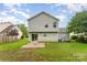 Backyard featuring a lush lawn, patio space, and view of the home's exterior at 2903 Rockingham Sw Ct, Concord, NC 28025