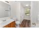 Bathroom with wood vanity and a window at 2903 Rockingham Sw Ct, Concord, NC 28025